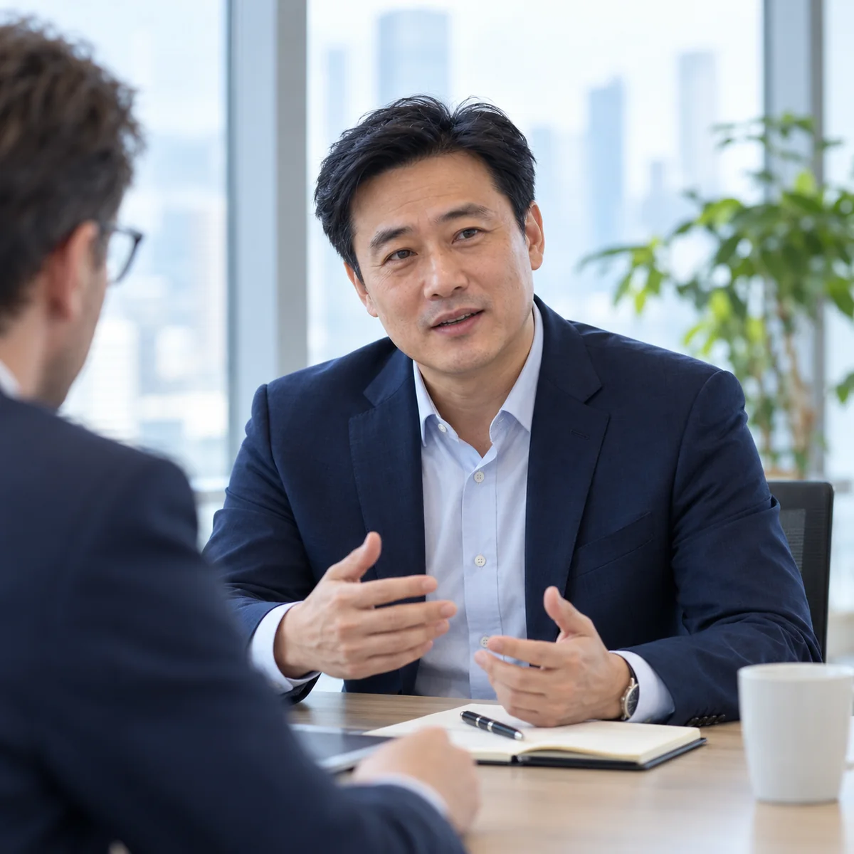 A Chinese businessman discussing a partnership with a colleague